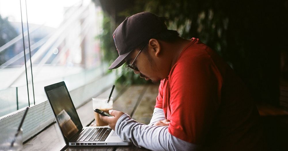 Man sitting with laptop (Unsplash)